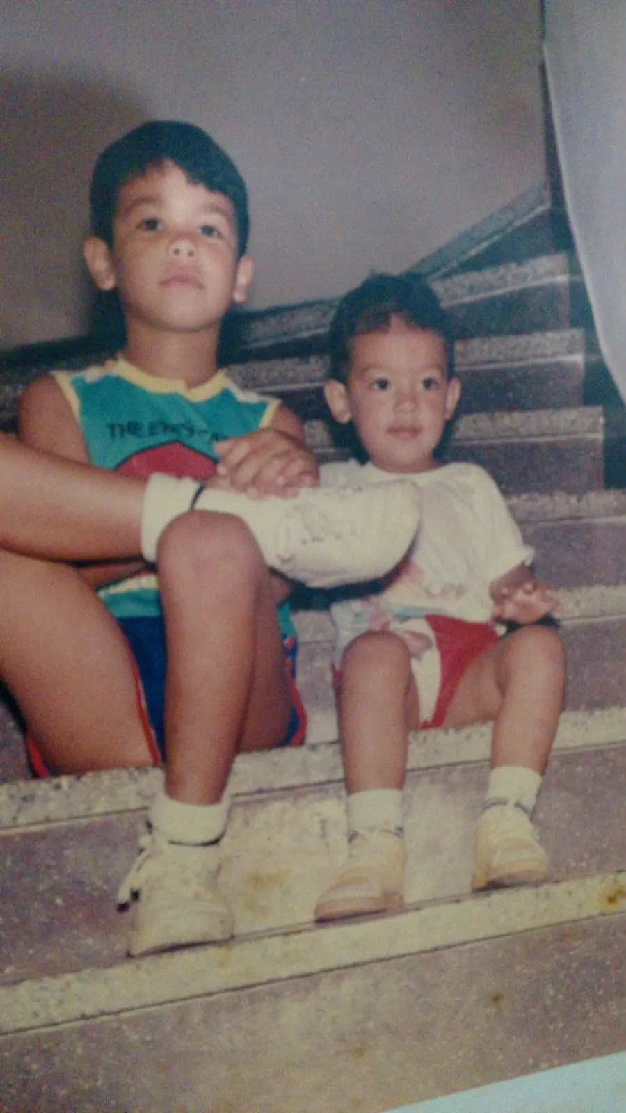 Anderson and his brother as small boys, sitting on a staircase