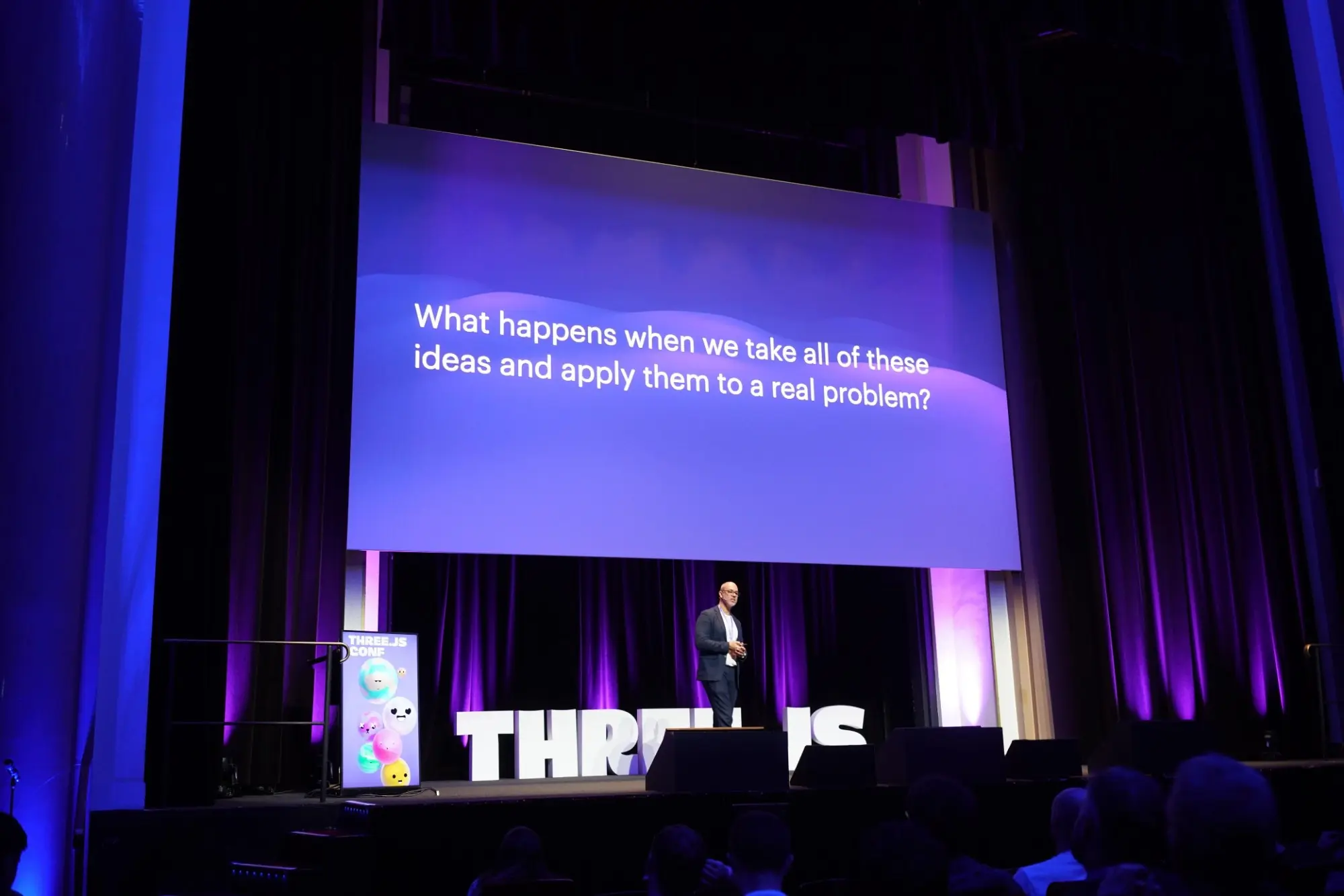 Anderson on stage at Three.js Conf Paris, under a slide that asks what happens when we take all of these ideas and apply them to a real problem