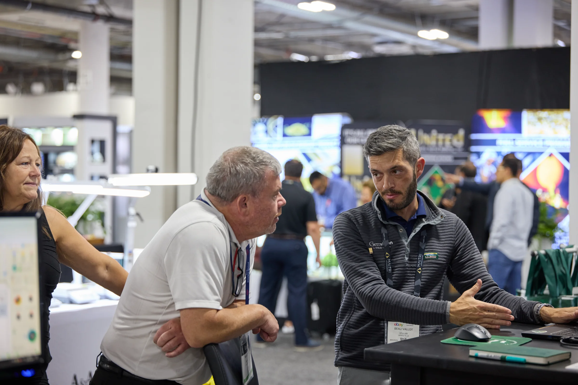 Beau Vallot talks with visitors at a Gemvision trade show booth