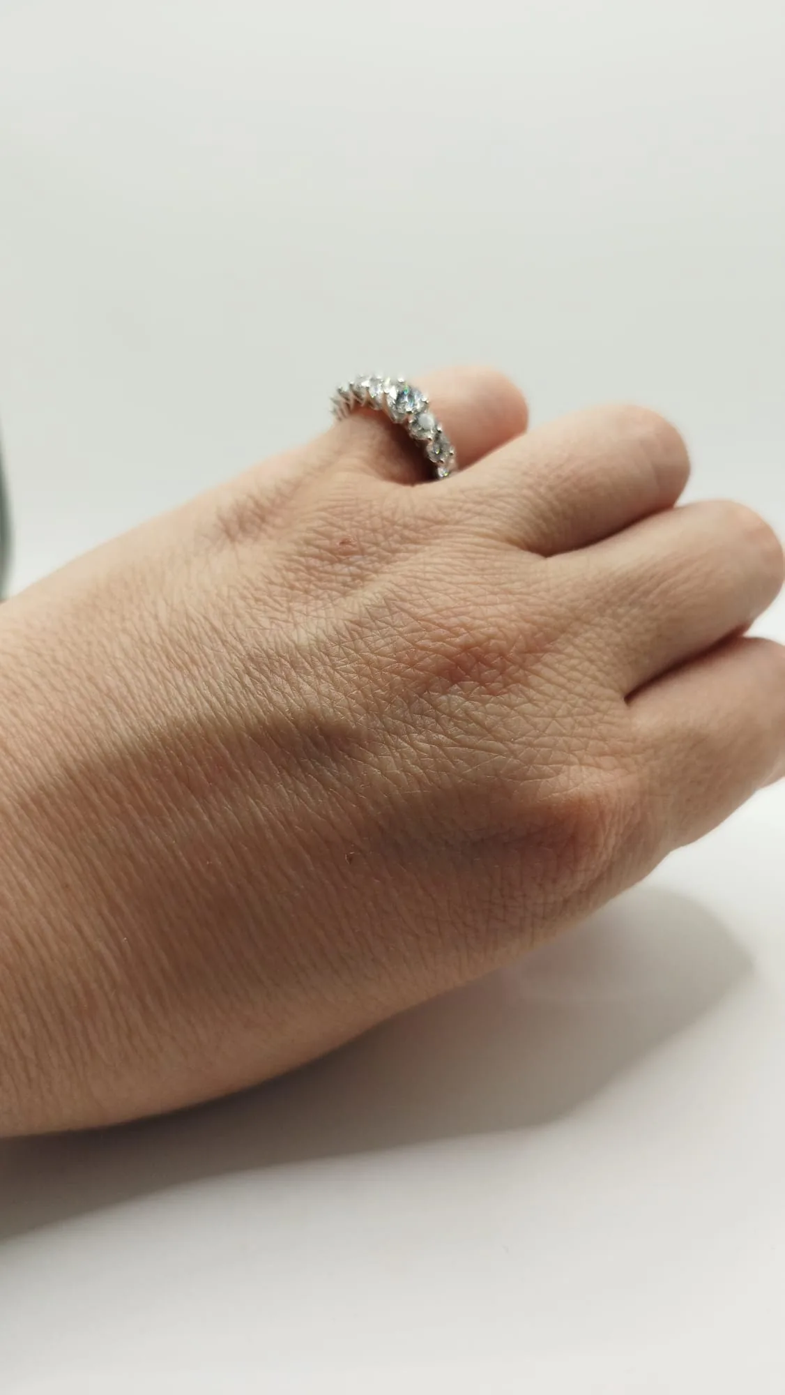 The finished diamond ring worn on a hand